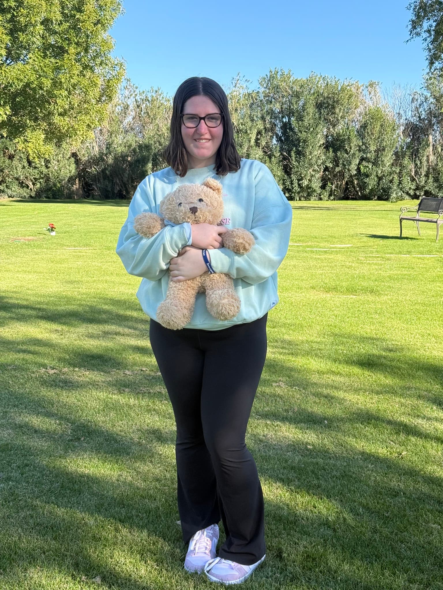 Kamrie Sippel smiling with a teddy bear
